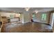Open-concept living space featuring hardwood floors and a view into the kitchen at 1062 Full Count Ln, Lancaster, SC 29720