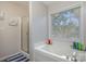 Bright bathroom with a large soaking tub and a separate glass-enclosed shower at 1136 Preakness Nw Ct, Concord, NC 28027