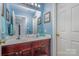 Bathroom features a double sink vanity, blue walls, and white trim at 1136 Preakness Nw Ct, Concord, NC 28027