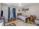 Bright bedroom with a wooden bed frame and a playful arrangement of toys and decor at 1136 Preakness Nw Ct, Concord, NC 28027