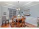 Cozy dining room with a four-chair wood table set, complemented by wainscoting at 1136 Preakness Nw Ct, Concord, NC 28027