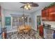 Charming dining area with a wood table, decorative ceiling fan, and views through the window at 1136 Preakness Nw Ct, Concord, NC 28027