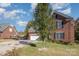 View of the home's exterior showcasing the brick facade, well-maintained lawn, and the driveway leading to the attached garage at 1136 Preakness Nw Ct, Concord, NC 28027