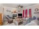 Comfortable living area with a fireplace, large windows with bright red drapes, and stylish furnishings creating a cozy ambiance at 1136 Preakness Nw Ct, Concord, NC 28027