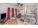 Comfortable living room featuring neutral tones, a fireplace, plush seating, and ample natural light through a large window at 1136 Preakness Nw Ct, Concord, NC 28027