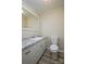Classic bathroom boasts granite counters, updated sink, white cabinets, and wooden floor at 1216 Stallion Ln, Lancaster, SC 29720