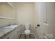 Classic bathroom boasts granite counters, updated sink, white cabinets and a toilet at 1216 Stallion Ln, Lancaster, SC 29720