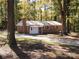 Ranch-style brick home with attached garage, nestled among mature trees at 1216 Stallion Ln, Lancaster, SC 29720