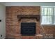 Living room featuring a brick fireplace with wood mantle and metal firebox at 1216 Stallion Ln, Lancaster, SC 29720