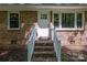 Stairway up to home's inviting front entrance with white door and brick steps at 1216 Stallion Ln, Lancaster, SC 29720