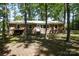 Ranch home featuring brick facade, landscaped yard, and wooded background at 1216 Stallion Ln, Lancaster, SC 29720