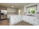 Bright kitchen with white cabinets, stainless steel appliances, and wood-look flooring at 1216 Stallion Ln, Lancaster, SC 29720