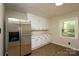 Kitchen area with stainless steel refrigerator and wood-look flooring at 1216 Stallion Ln, Lancaster, SC 29720