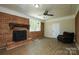 Cozy living room featuring a brick fireplace and ample seating space at 1216 Stallion Ln, Lancaster, SC 29720