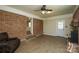 Inviting living room with brick accents, a fireplace, and hardwood floors at 1216 Stallion Ln, Lancaster, SC 29720