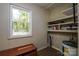 Interior view of shed with shelving, water heater, small window and dark woodgrain flooring at 1216 Stallion Ln, Lancaster, SC 29720