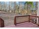 View from a backyard deck with stained wood railings overlooking a wooded area at 127 High Ridge Rd, Mooresville, NC 28117