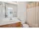 Bathroom featuring a vanity with a mirror, and shower-tub combo at 127 High Ridge Rd, Mooresville, NC 28117