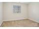 Bedroom featuring a window with blinds, neutral carpet, and fresh paint at 127 High Ridge Rd, Mooresville, NC 28117