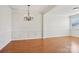 Dining room featuring hardwood floors, white trim and a decorative chandelier at 127 High Ridge Rd, Mooresville, NC 28117