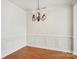 Spacious room with decorative trim, hardwood flooring, and modern lighting at 127 High Ridge Rd, Mooresville, NC 28117