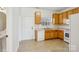 Kitchen with oak cabinets, white appliances, and tile floor at 127 High Ridge Rd, Mooresville, NC 28117