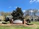 Entrance sign for Sunridge, surrounded by manicured landscaping and seasonal flowers at 127 High Ridge Rd, Mooresville, NC 28117