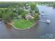 Expansive waterfront property with a lush lawn, private dock, and stunning lake views at 18210 Pompano Pl, Cornelius, NC 28031
