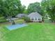 Spacious backyard featuring a guest house, basketball court, and manicured lawn at 18210 Pompano Pl, Cornelius, NC 28031