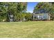Lush backyard featuring a basketball court and a charming guest house at 18210 Pompano Pl, Cornelius, NC 28031