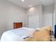 Relaxing bedroom with a cozy bed, wooden dresser, and a large closet with sliding doors at 18210 Pompano Pl, Cornelius, NC 28031