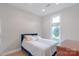 A cozy bedroom with a plush headboard, bright natural light, and clean decor at 18210 Pompano Pl, Cornelius, NC 28031