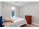 Bright bedroom with hardwood floors, a comfortable bed, and a classic wooden dresser at 18210 Pompano Pl, Cornelius, NC 28031