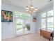 Dining area with a chandelier, large windows, and access to the outdoors at 18210 Pompano Pl, Cornelius, NC 28031