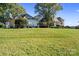 Expansive lawn view of an estate home and outbuilding with basketball hoop, perfect for outdoor recreation and luxury living at 18210 Pompano Pl, Cornelius, NC 28031