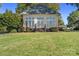 Exterior of a guest house with ample windows and a well-kept lawn at 18210 Pompano Pl, Cornelius, NC 28031
