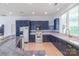 Well-lit kitchen showcasing blue cabinets, tiled backsplash, and a functional layout with modern appliances at 18210 Pompano Pl, Cornelius, NC 28031