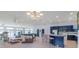 Open-concept kitchen and great room with blue cabinets, a tiled bar, and abundant natural light at 18210 Pompano Pl, Cornelius, NC 28031