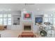 Comfortable living room with a fireplace, built-in shelving, and views of the outside at 18210 Pompano Pl, Cornelius, NC 28031