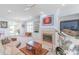 Bright living room featuring built-in shelves, a fireplace, and outdoor access at 18210 Pompano Pl, Cornelius, NC 28031