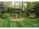 Backyard with a water feature, lush landscaping, and manicured lawn at 1919 Kensal Ct, Charlotte, NC 28211