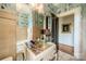 Charming bathroom with patterned wallpaper, vintage vanity, and chandelier lighting at 1919 Kensal Ct, Charlotte, NC 28211