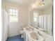 Bathroom featuring double sinks, blue tile floor, and a large mirror, providing a functional space at 1919 Kensal Ct, Charlotte, NC 28211