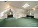 Bonus room offering versatile space with skylights, built-in shelving, and carpeted flooring at 1919 Kensal Ct, Charlotte, NC 28211