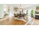 Bright dining room with hardwood floors, a large table, and access to the kitchen at 1919 Kensal Ct, Charlotte, NC 28211