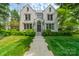 Stunning stone home with manicured lawn, mature trees, and a welcoming walkway leading to the front door at 1919 Kensal Ct, Charlotte, NC 28211