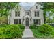 Stately stone exterior with arched entryway, lush landscaping and mature trees enhances curb appeal at 1919 Kensal Ct, Charlotte, NC 28211