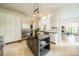 Open kitchen with stainless steel appliances, an island, and a view into the living room at 1919 Kensal Ct, Charlotte, NC 28211