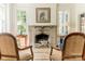 Bright living room with fireplace, hardwood floors, comfortable seating arrangement, and stylish decor at 1919 Kensal Ct, Charlotte, NC 28211