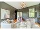 Elegant sitting room with hardwood floors, three comfortable chairs, and arched doorway at 1919 Kensal Ct, Charlotte, NC 28211